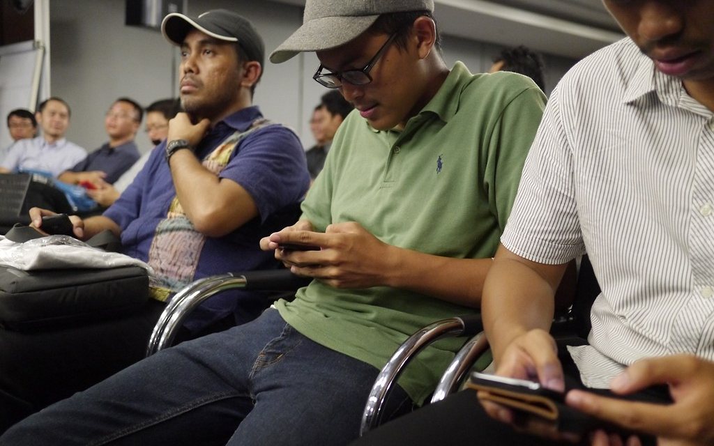 Passengers waiting, each one in a messaging app.