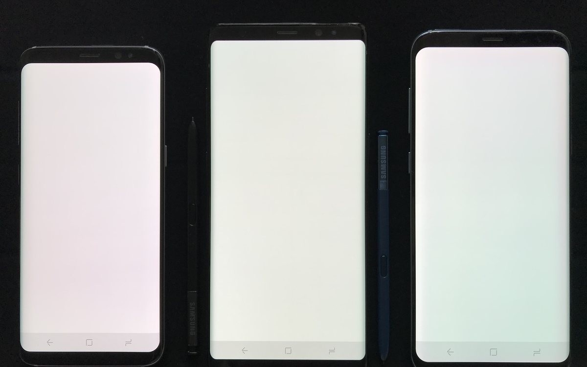 Three handsets side by side with their panels driven to full white.
